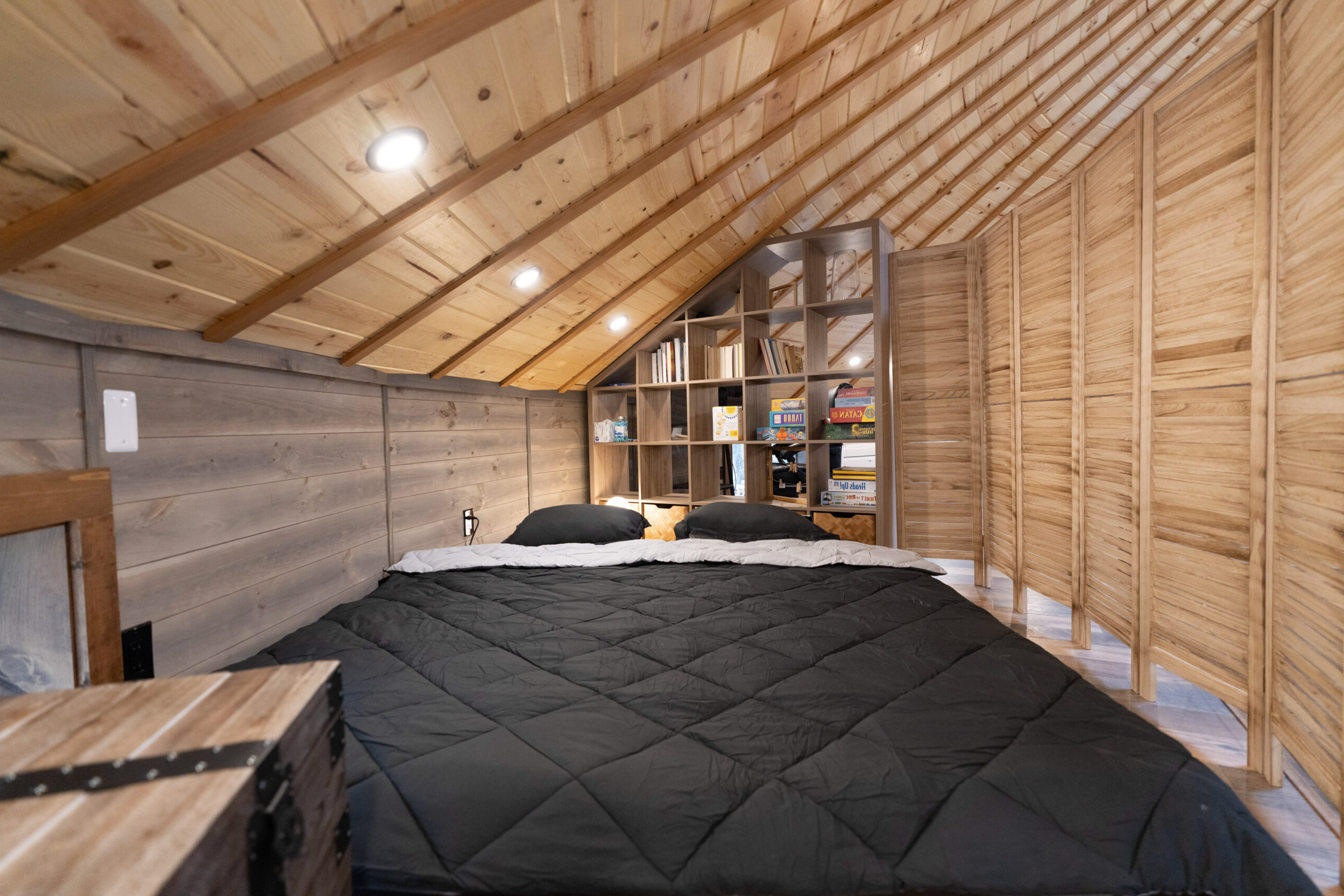 Floor sofa transformed into KING size bed with a privacy screen -- Skyline Yurt, Skyline Cabin