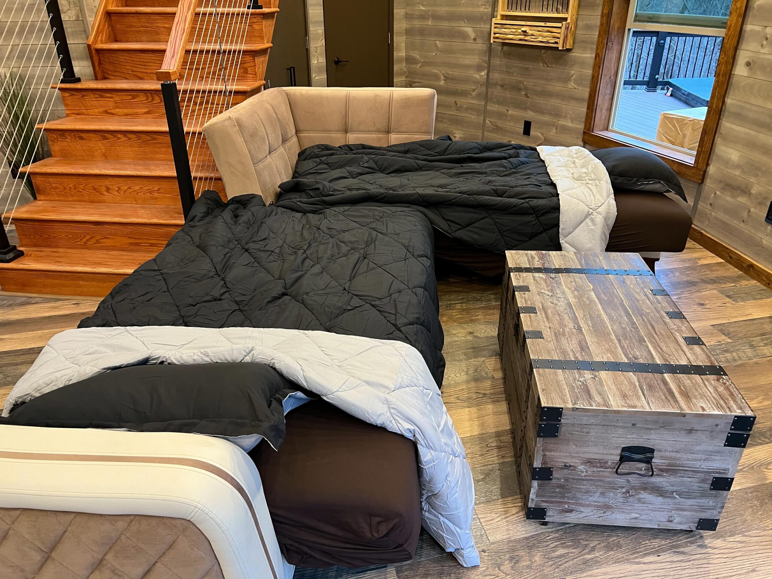 The living room sofa transforms into two half-separate beds -- Skyline Yurt, Skyline Cabin